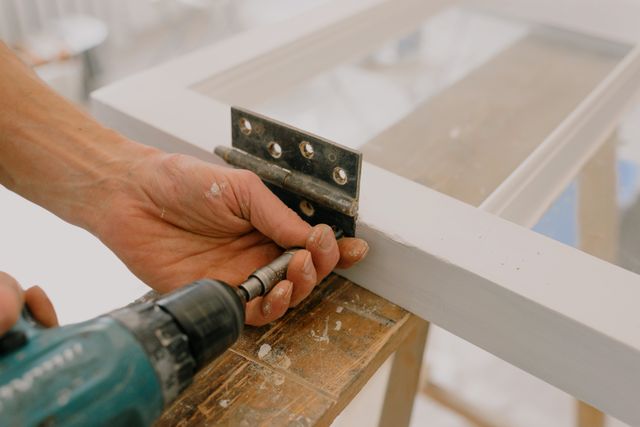 a person fixing a windowsill